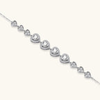 Complete jewelry set with heart-shaped sterling silver pieces featuring brilliant moissanite stones on white background.