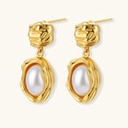 Gold-plated textured stud earrings with white freshwater pearl drops against cream background, showing organic rippled design