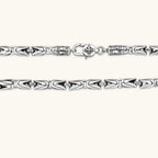 Men's antique silver Byzantine chain necklace, 6.2mm wide interlocking S-link pattern with ornate lobster clasp, 560mm length.
